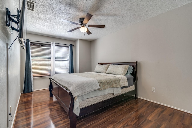 bedroom with baseboards, a textured ceiling, ceiling fan, and wood finished floors