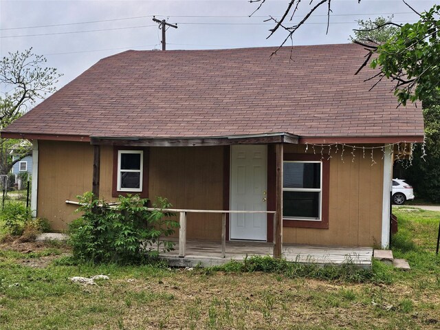 view of front of home with a porch and a shingled roof
