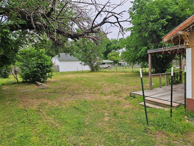 view of yard with a deck and fence