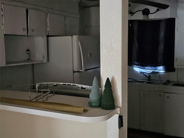 kitchen featuring freestanding refrigerator and a sink