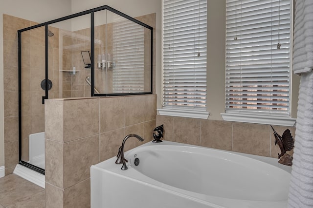 bathroom featuring a bath and a shower stall