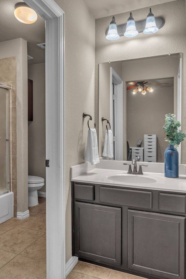 full bath featuring ceiling fan, tile patterned flooring, vanity, toilet, and baseboards
