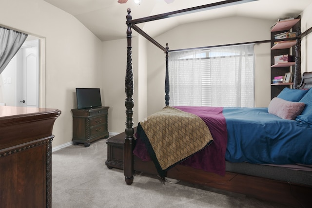 carpeted bedroom featuring baseboards and vaulted ceiling