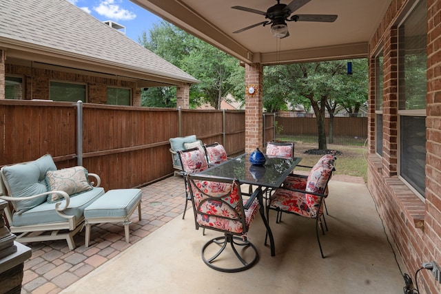 view of patio with a ceiling fan, a fenced backyard, and outdoor dining space