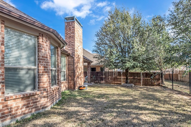 view of yard with a fenced backyard