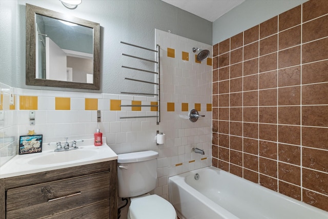 bathroom with shower / bathtub combination, toilet, tile walls, and vanity