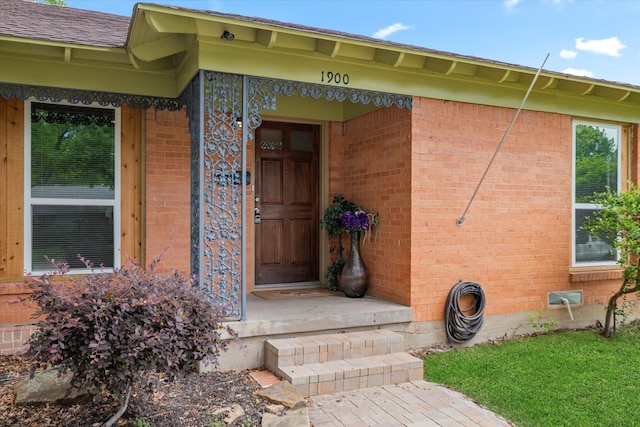 entrance to property with brick siding