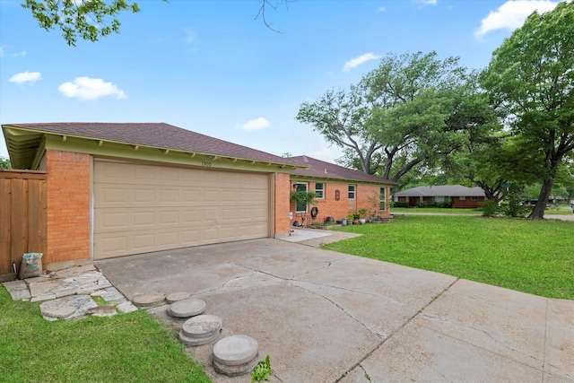 ranch-style house featuring a front yard, roof with shingles, brick siding, an attached garage, and driveway