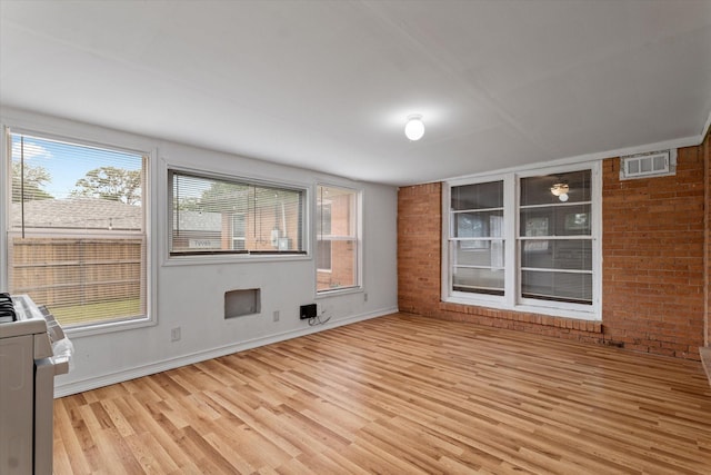 interior space with light wood-style floors, baseboards, and visible vents