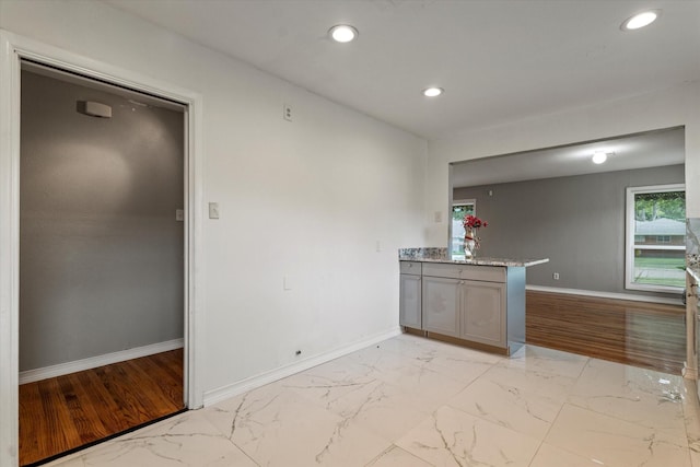 kitchen featuring gray cabinetry, baseboards, recessed lighting, and marble finish floor