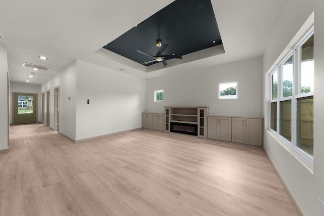 928 College St, Sulphur Springs, TX 75482 - unfurnished living room with light wood-style floors, baseboards, a wealth of natural light, and visible vents