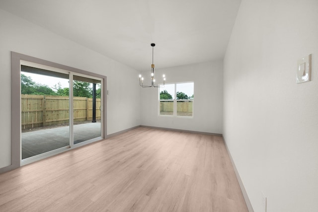 928 College St, Sulphur Springs, TX 75482 - spare room with an inviting chandelier, baseboards, light wood finished floors, and a healthy amount of sunlight
