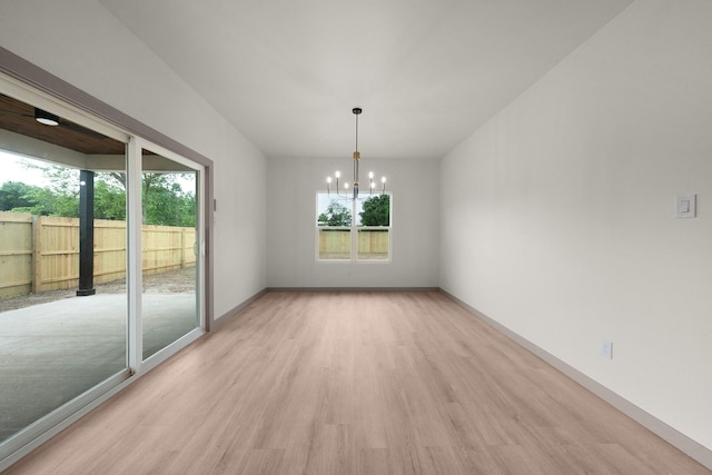928 College St, Sulphur Springs, TX 75482 - unfurnished dining area featuring baseboards, a notable chandelier, a healthy amount of sunlight, and light wood-style flooring