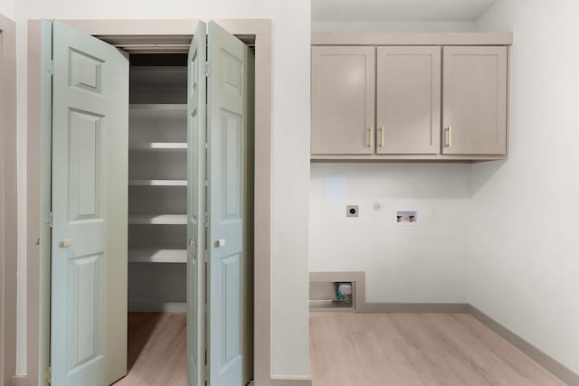 928 College St, Sulphur Springs, TX 75482 - laundry room featuring hookup for an electric dryer, cabinet space, baseboards, hookup for a washing machine, and light wood-style flooring