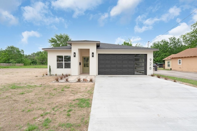 928 College St, Sulphur Springs, TX 75482 - prairie-style house featuring a garage, stucco siding, concrete driveway, and a shingled roof