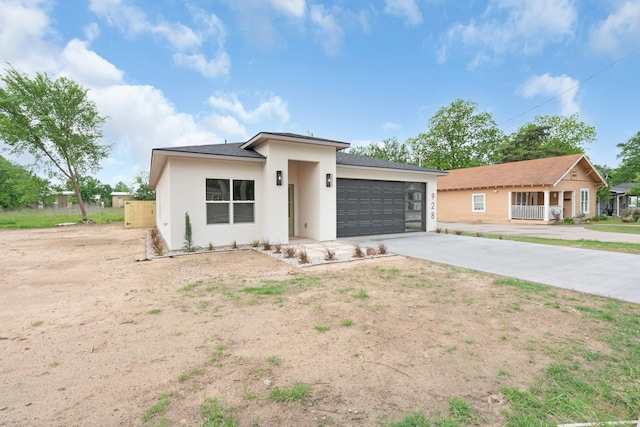 928 College St, Sulphur Springs, TX 75482 - view of front facade with an attached garage, driveway, and stucco siding
