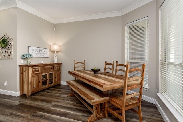 dining space featuring crown molding, dark wood-style flooring, and baseboards