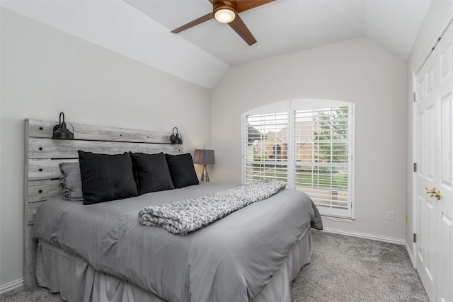 bedroom featuring baseboards, carpet flooring, ceiling fan, and vaulted ceiling