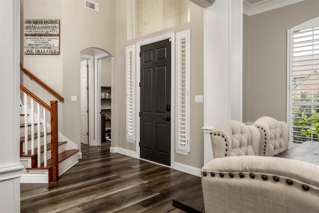 entryway featuring visible vents, baseboards, stairway, dark wood-type flooring, and arched walkways