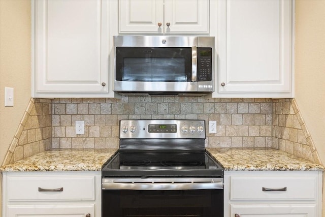 309 Nash Dr, Hewitt, TX 76643 - kitchen with white cabinetry, appliances with stainless steel finishes, light stone counters, and tasteful backsplash