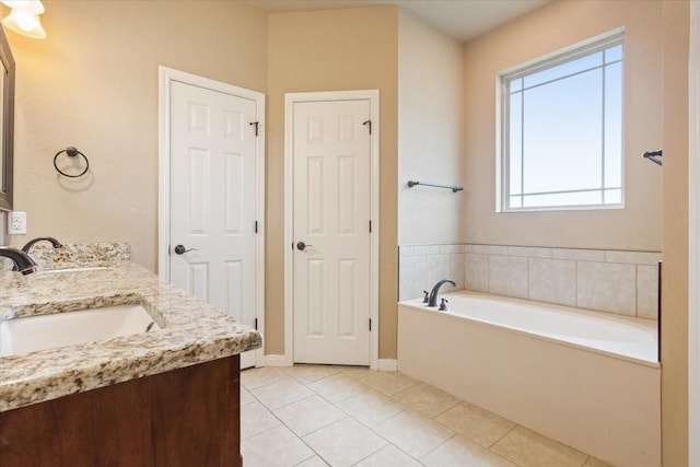 309 Nash Dr, Hewitt, TX 76643 - full bath featuring double vanity, baseboards, a bath, tile patterned floors, and a sink