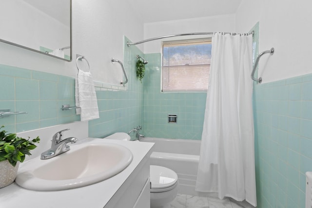 bathroom featuring tile walls, vanity, toilet, marble finish floor, and shower / tub combo with curtain