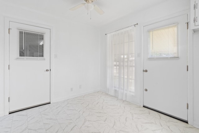 foyer entrance with a ceiling fan