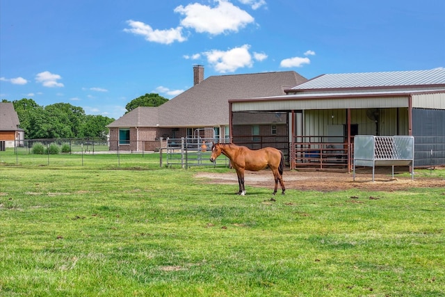 back of property with an outbuilding, a chimney, and an exterior structure