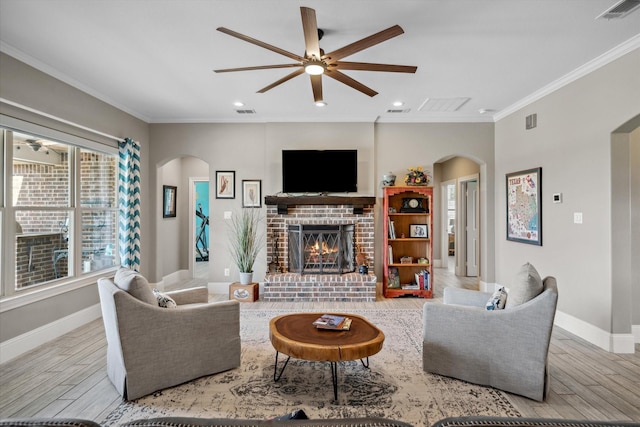 living room with arched walkways, a ceiling fan, wood finished floors, and visible vents