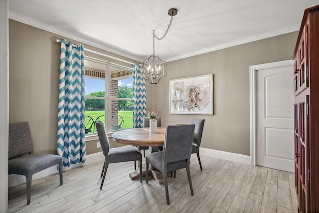 dining area with crown molding, baseboards, light wood-type flooring, and a chandelier