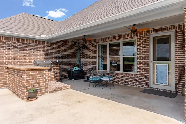 view of patio with grilling area, a ceiling fan, outdoor dining space, and area for grilling