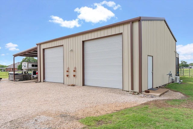 garage with driveway and a garage