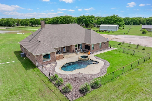 view of pool with a fenced backyard, a yard, central AC, and a patio area