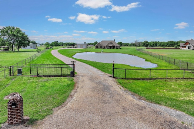 view of community featuring fence and a yard