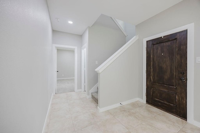 3600 Howard St, Fort Worth, TX 76119 - foyer entrance featuring stairway, baseboards, light tile patterned floors, and recessed lighting