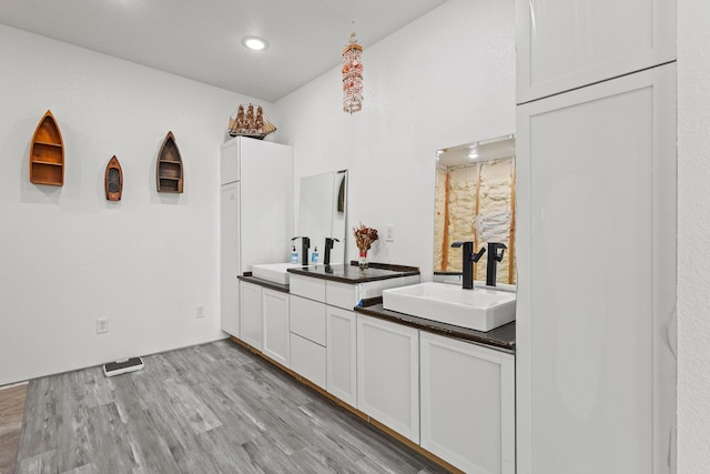 bar with a sink, light wood-style floors, and recessed lighting