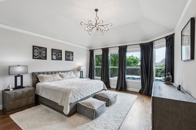 bedroom with ornamental molding, an inviting chandelier, multiple windows, and wood finished floors