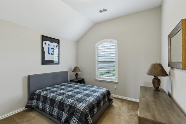 carpeted bedroom featuring baseboards, vaulted ceiling, and visible vents