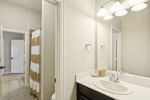 bathroom featuring vanity, a shower with shower curtain, tile patterned floors, and toilet