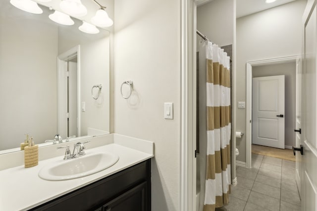 bathroom featuring a shower with curtain, tile patterned floors, vanity, and toilet