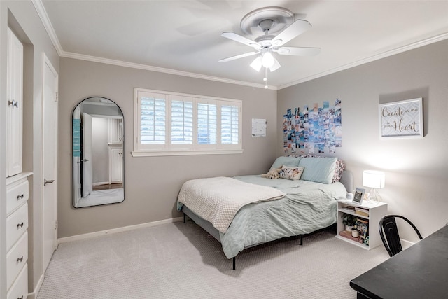 carpeted bedroom with crown molding, baseboards, and ceiling fan