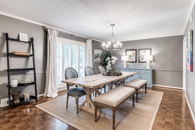 dining area featuring baseboards, an inviting chandelier, and ornamental molding