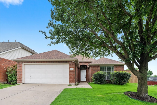 ranch-style house with an attached garage, brick siding, a front yard, and concrete driveway