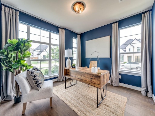 home office featuring baseboards and wood finished floors