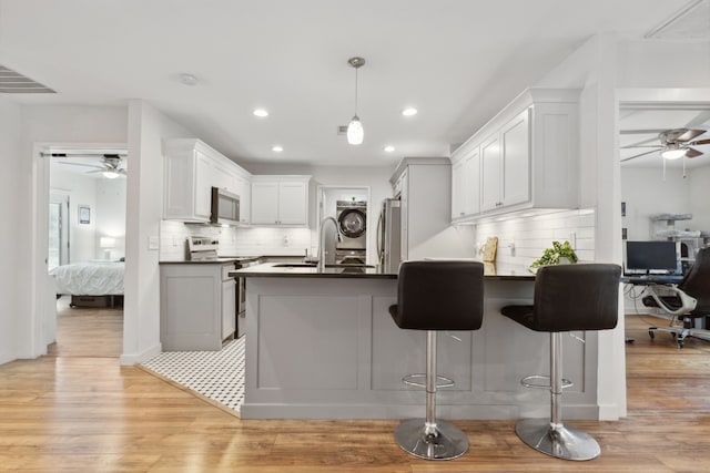 kitchen featuring dark countertops, appliances with stainless steel finishes, and ceiling fan