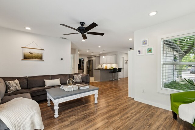 living room featuring recessed lighting, ceiling fan, light wood-type flooring, and visible vents
