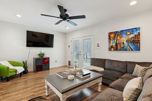 living area featuring a ceiling fan, french doors, baseboards, light wood finished floors, and recessed lighting