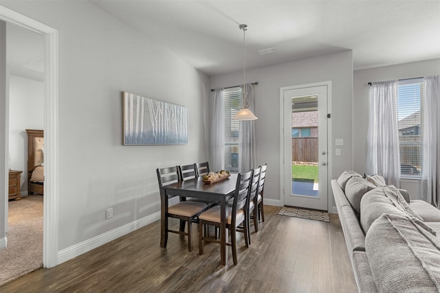 dining room featuring baseboards and dark wood finished floors