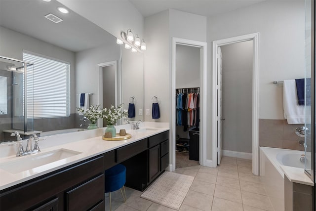 full bathroom featuring a sink, a garden tub, and visible vents