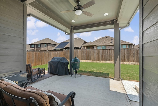view of patio with grilling area, a ceiling fan, and a fenced backyard
